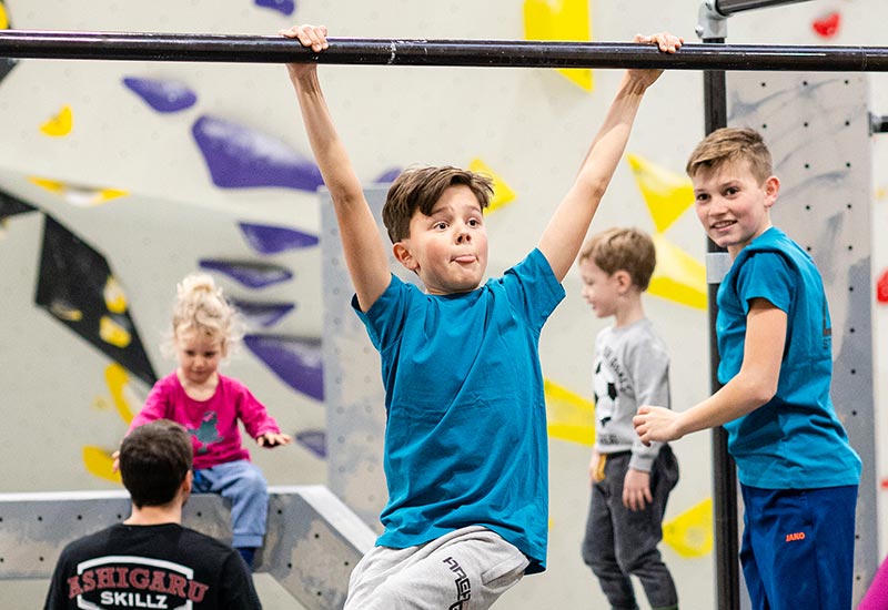 Kinder trainieren gemeinsam im Parkourbereich